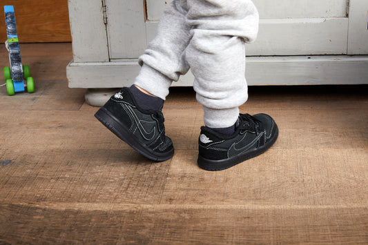kid wearing air jordan 1 low travis scott black phantom kids on foot