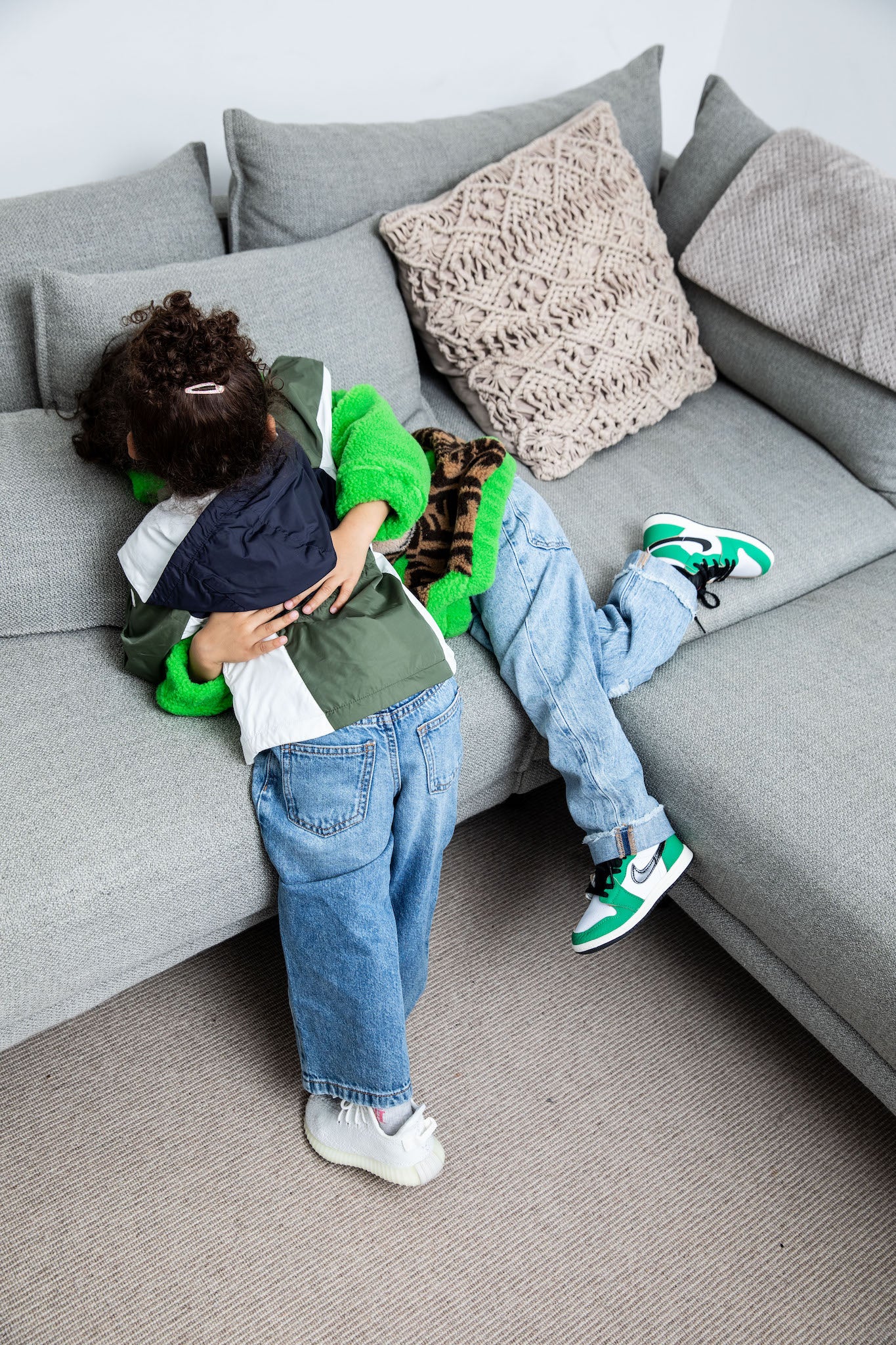 little boy wearing Air Jordan 1 High Kids 'Lucky Green' on foot