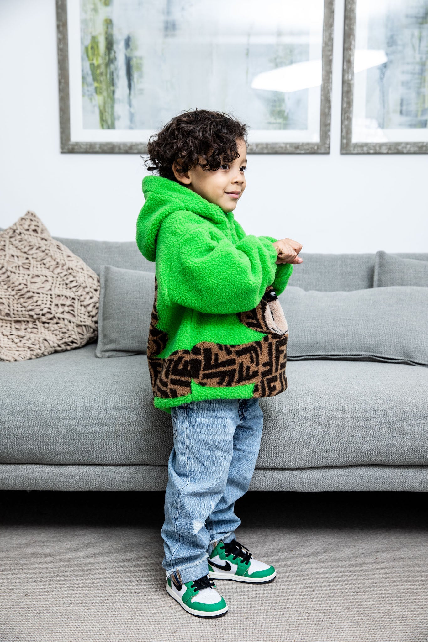 little boy wearing Air Jordan 1 High Kids 'Lucky Green' on foot