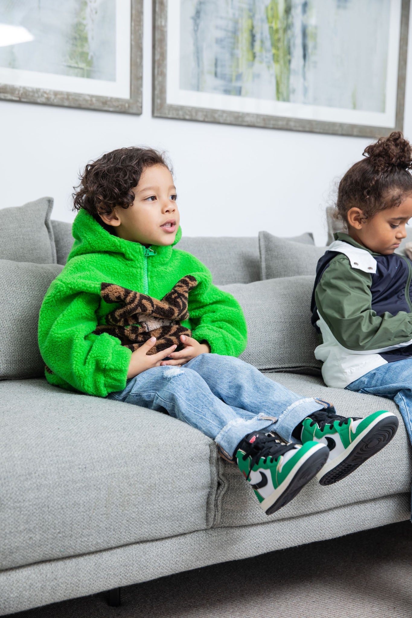 little boy wearing Air Jordan 1 High Kids 'Lucky Green' on foot