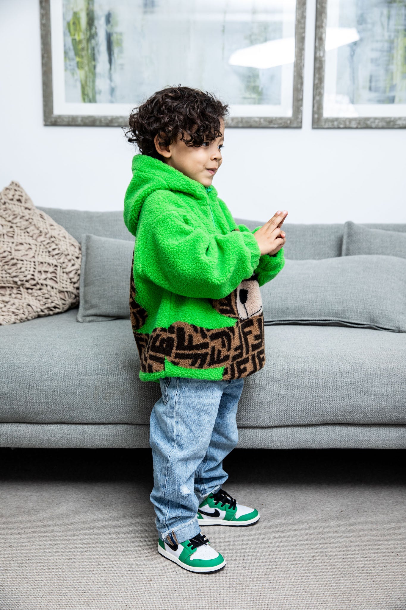 little boy wearing Air Jordan 1 High Kids 'Lucky Green' on foot