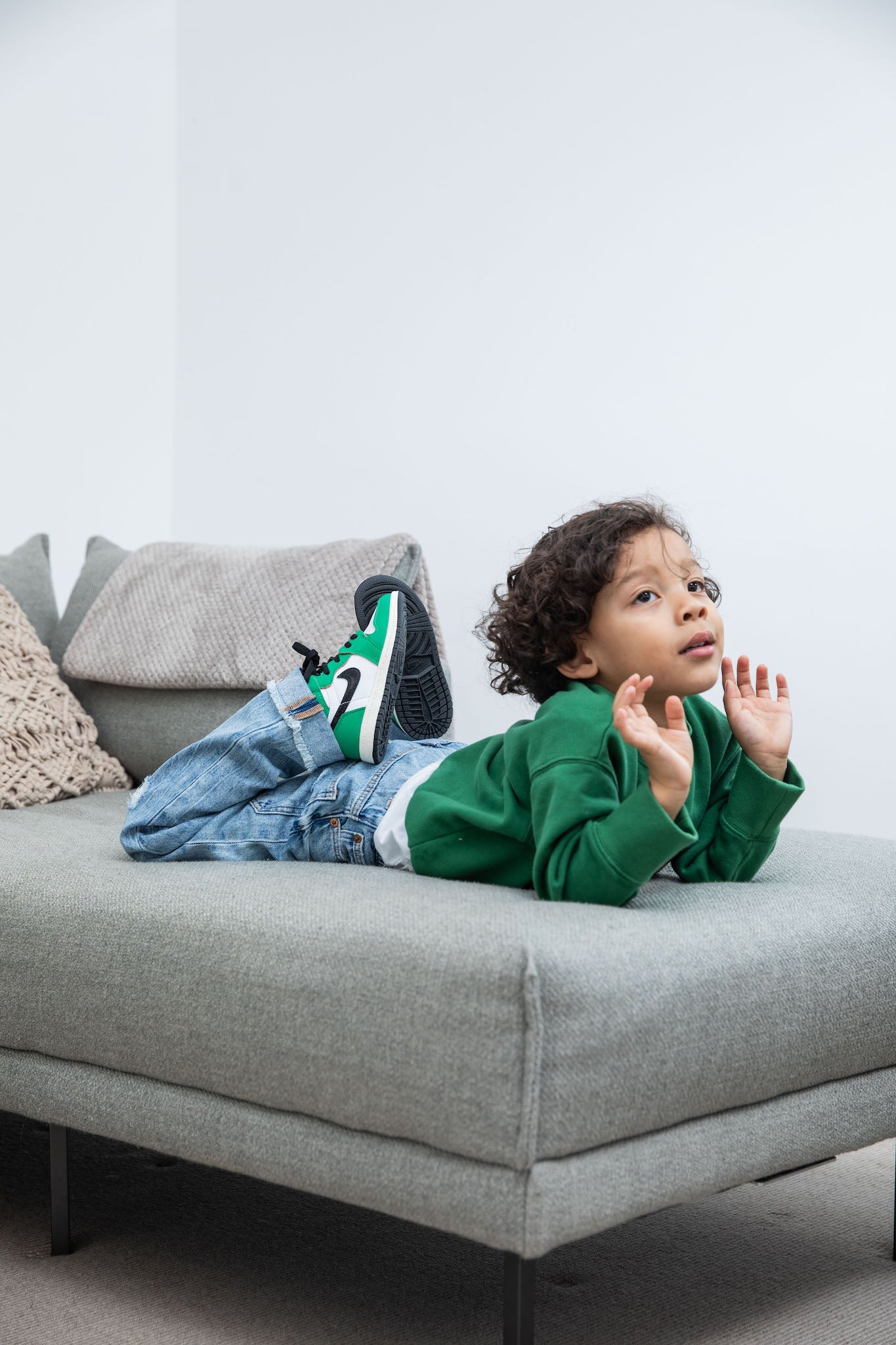 little boy wearing Air Jordan 1 High Kids 'Lucky Green' on foot