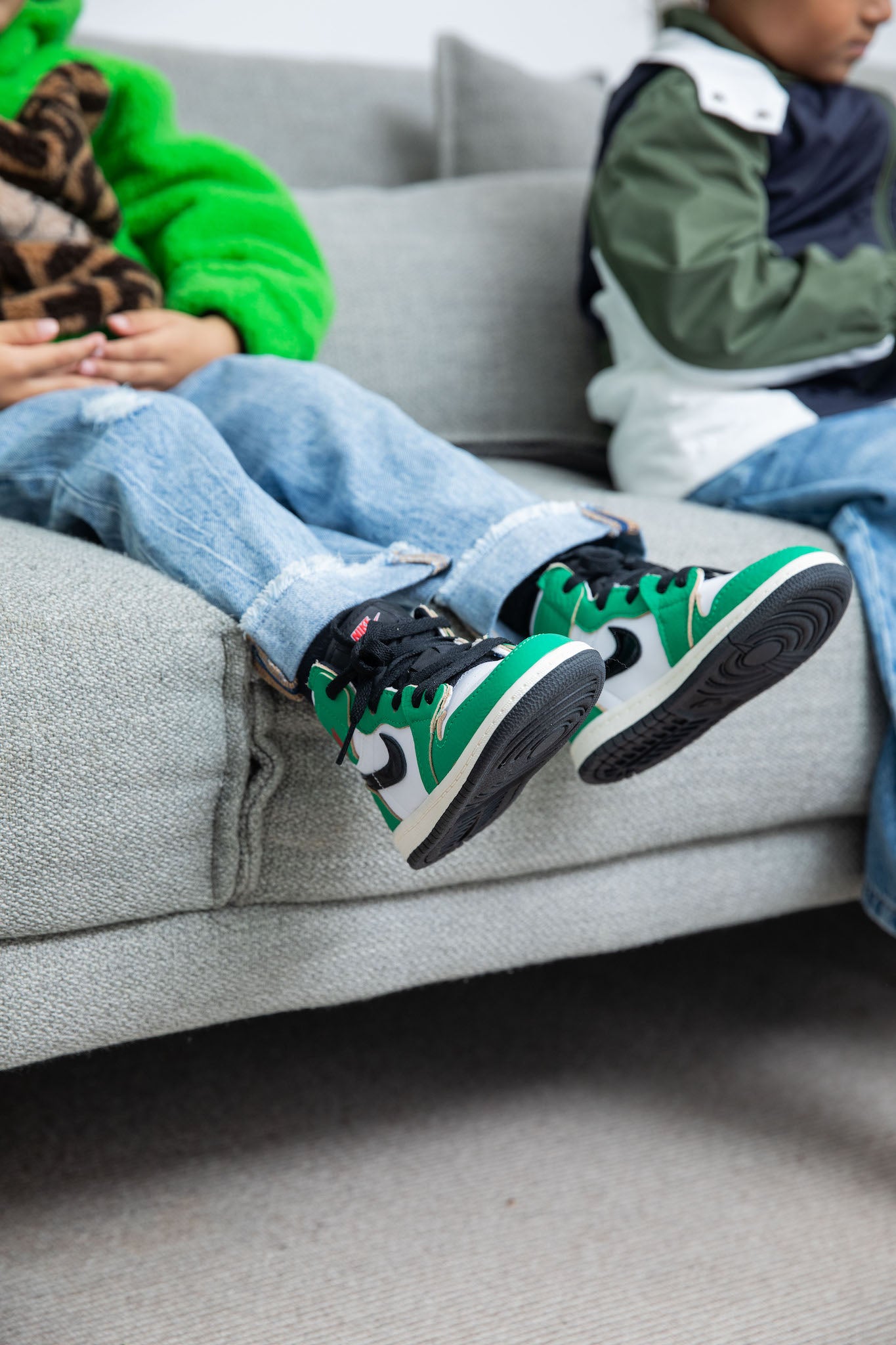 little boy wearing Air Jordan 1 High Kids 'Lucky Green' on foot