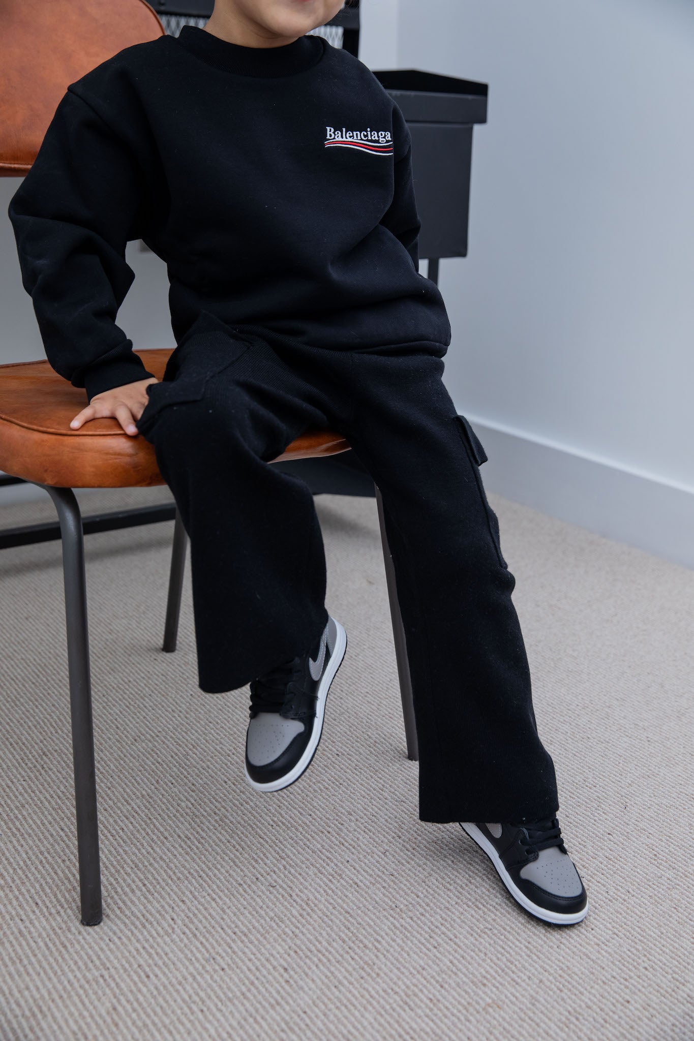 little boy wearing air jordan 1 high kids shadow on foot