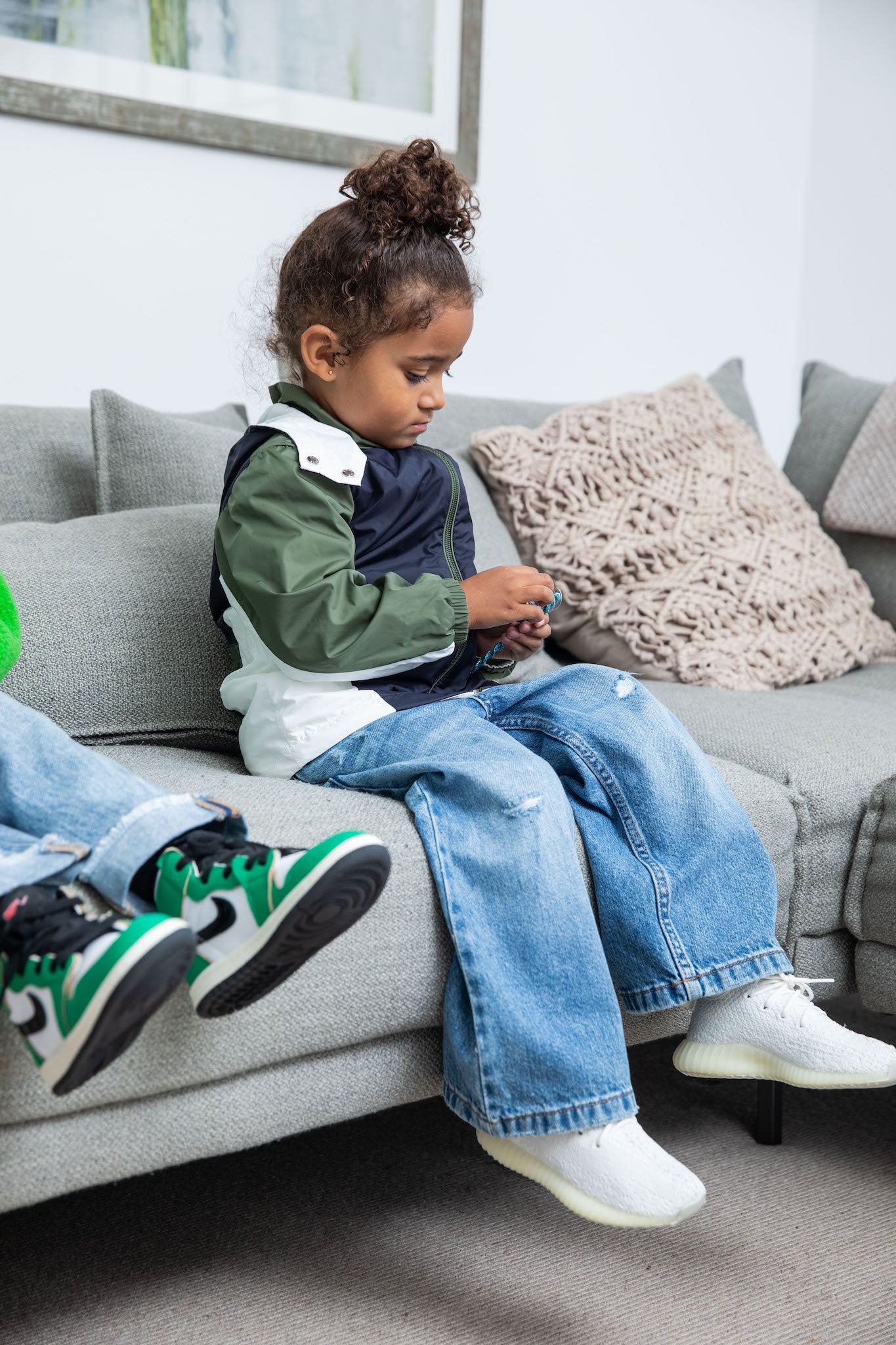 little girl wearing Adidas Yeezy Boost 350 V2 Kids 'Cream' on foot