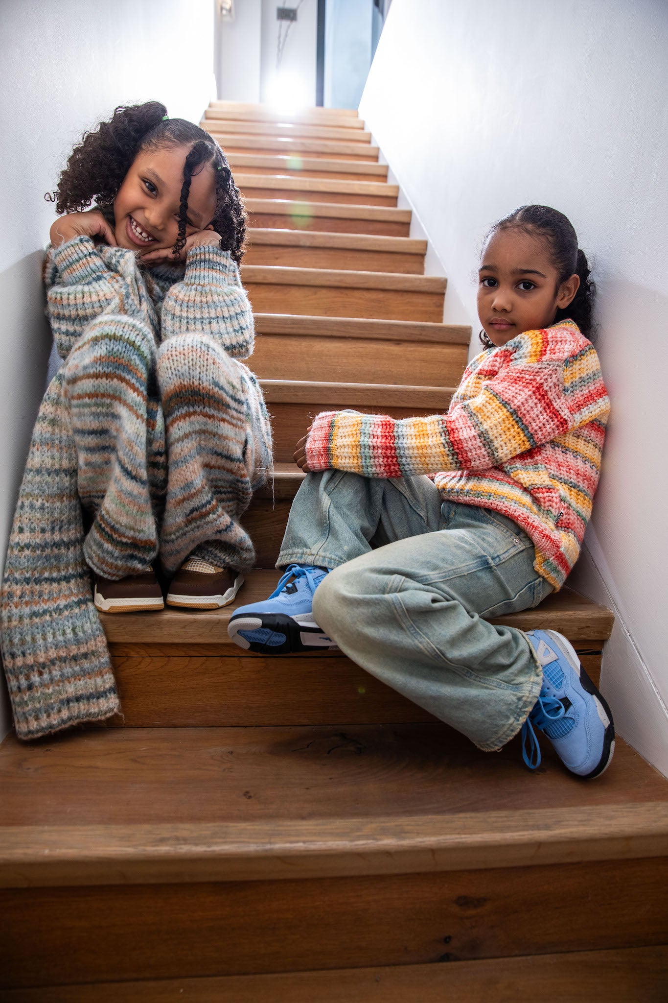 girl wearing Air Jordan 4 Kids 'University Blue' on foot