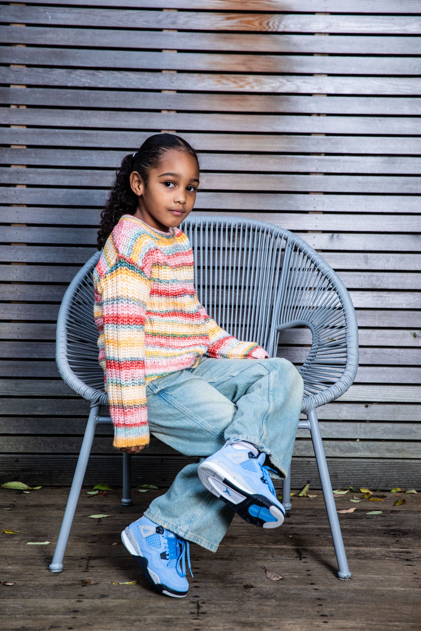 girl wearing Air Jordan 4 Kids 'University Blue' on foot