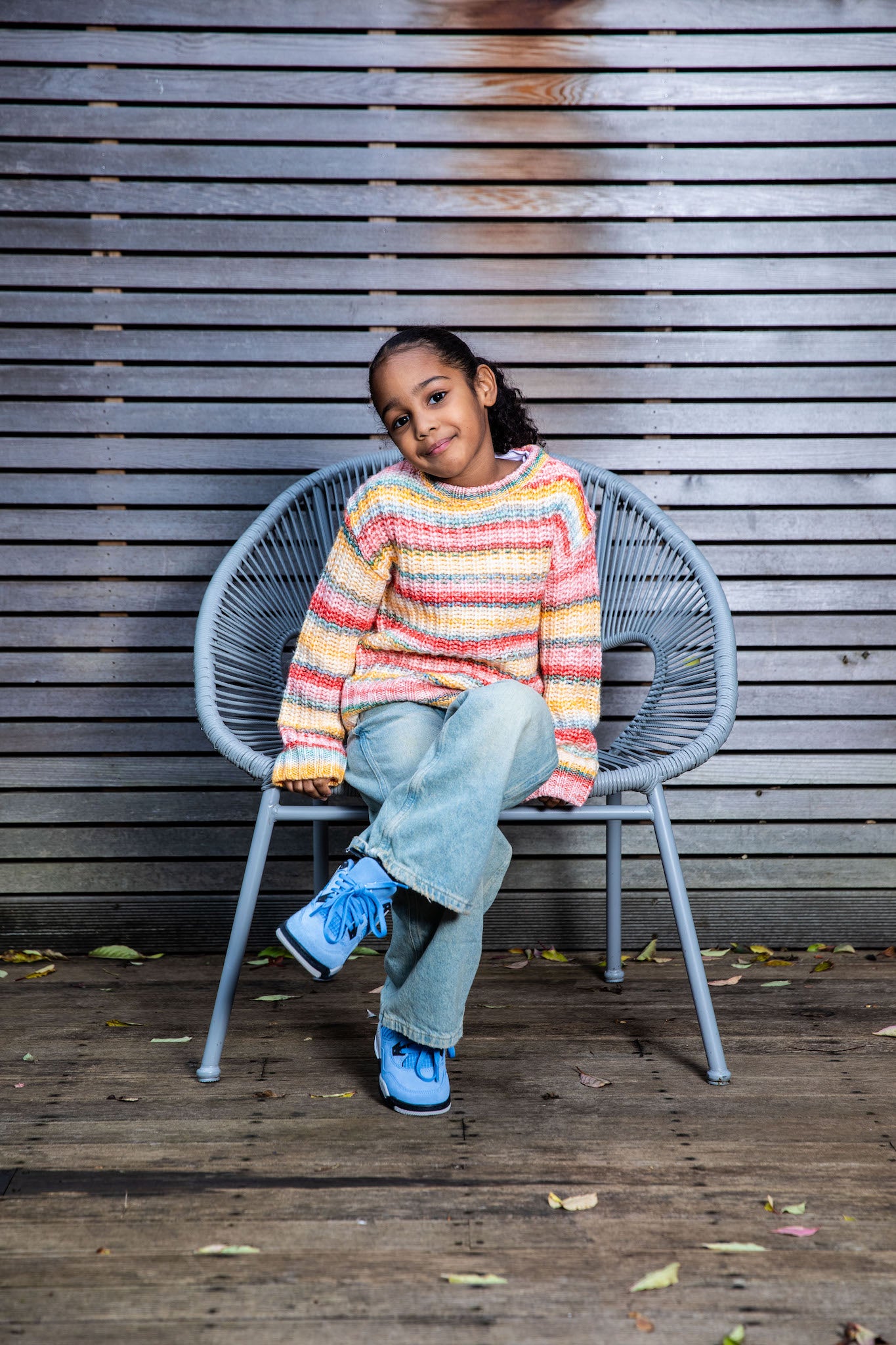 girl wearing Air Jordan 4 Kids 'University Blue' on foot