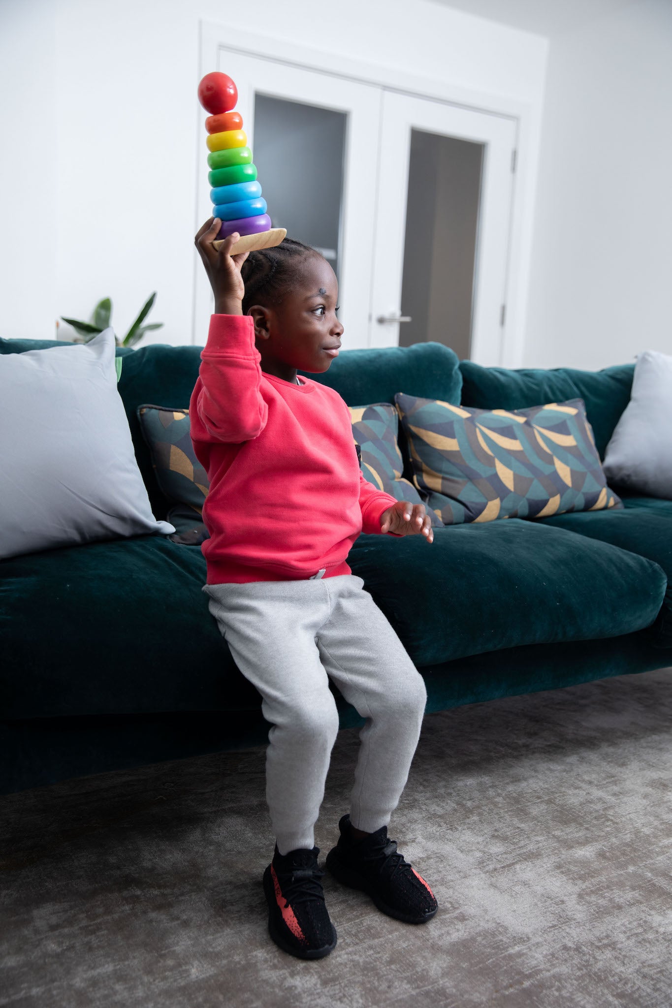 kid wearing Adidas Yeezy Boost 350 V2 Kids 'Core Black Red' on foot