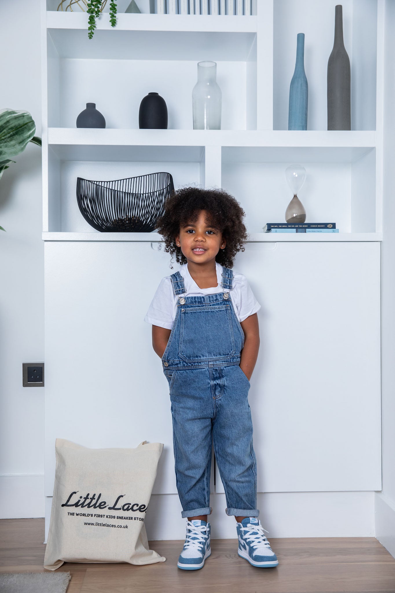 little girl wearing Air Jordan 1 High Kids 'Denim' on foot