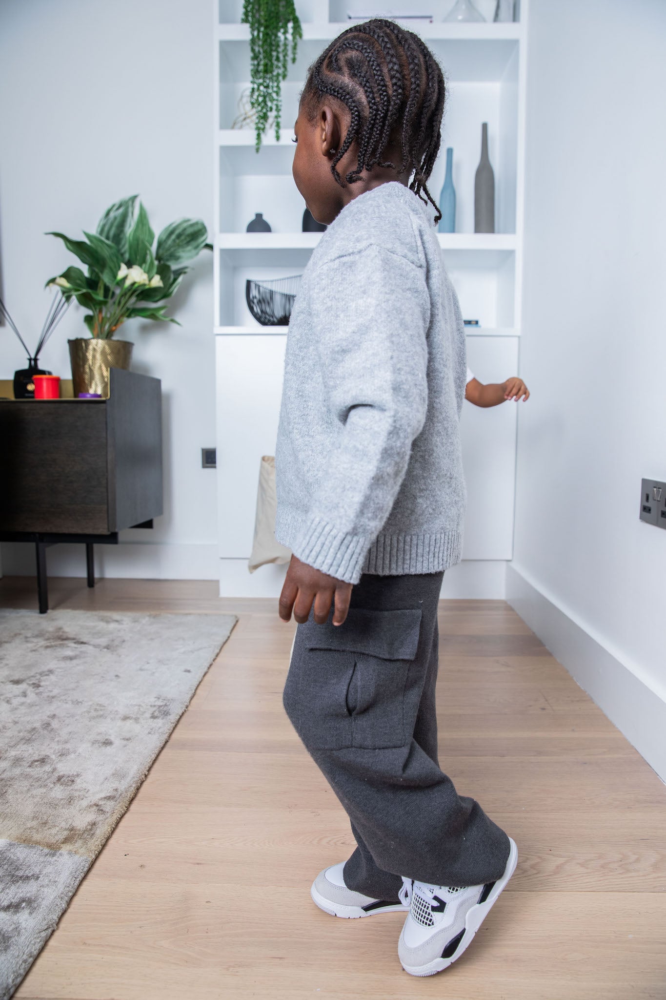little boy wearing Air Jordan 4 Kids 'Military Black' on foot