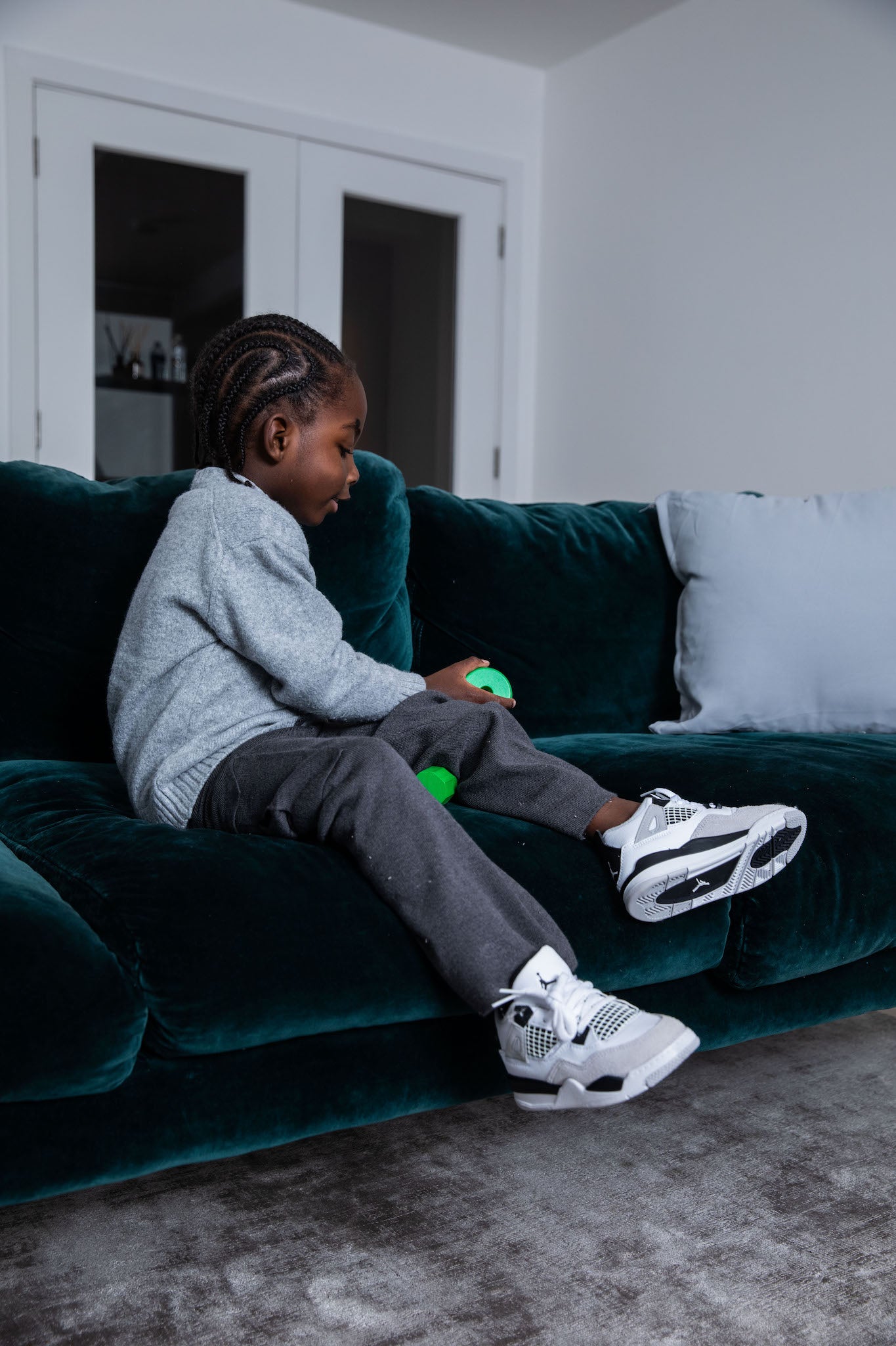 little boy wearing Air Jordan 4 Kids 'Military Black' on foot