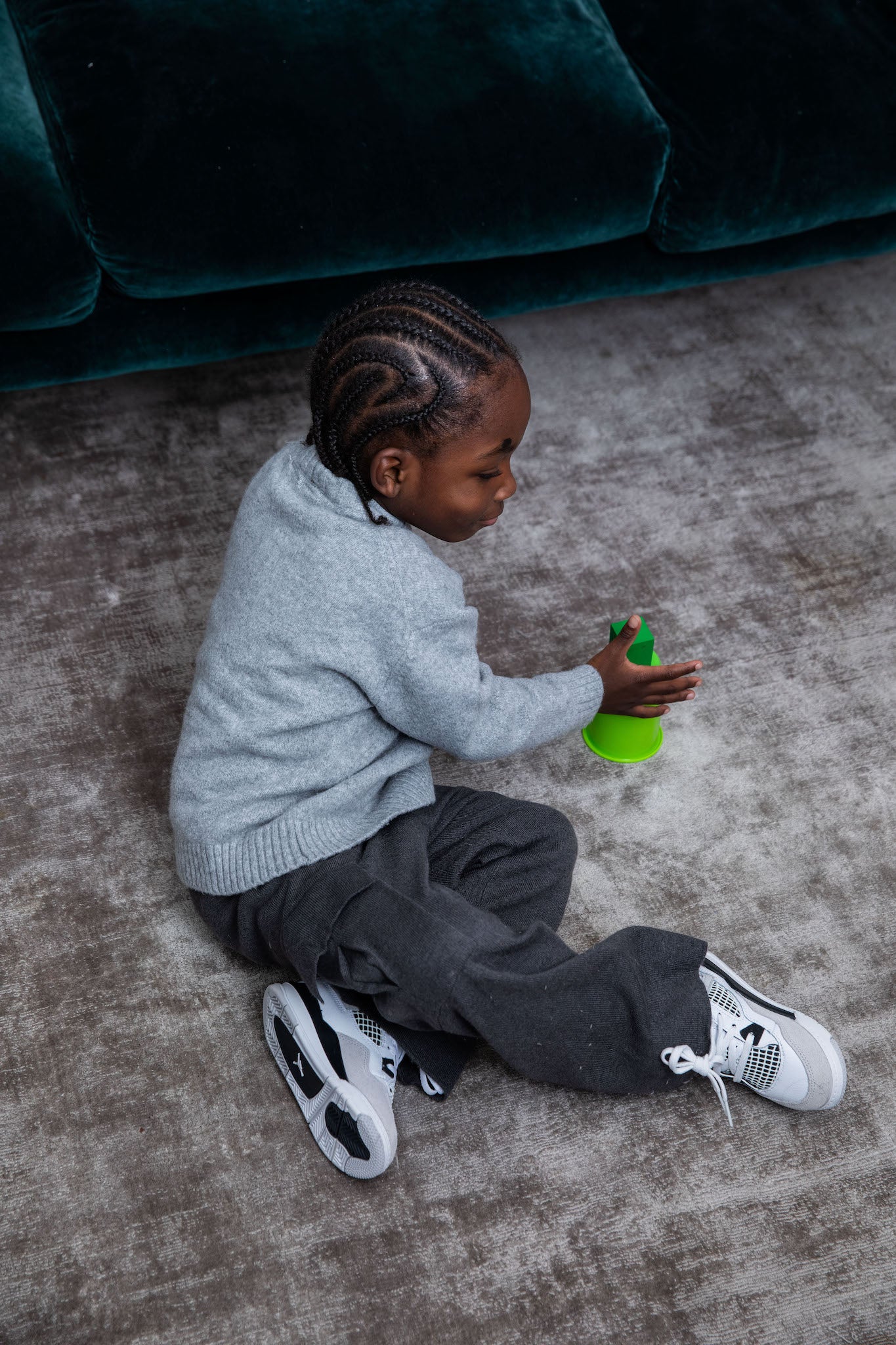 little boy wearing Air Jordan 4 Kids 'Military Black' on foot