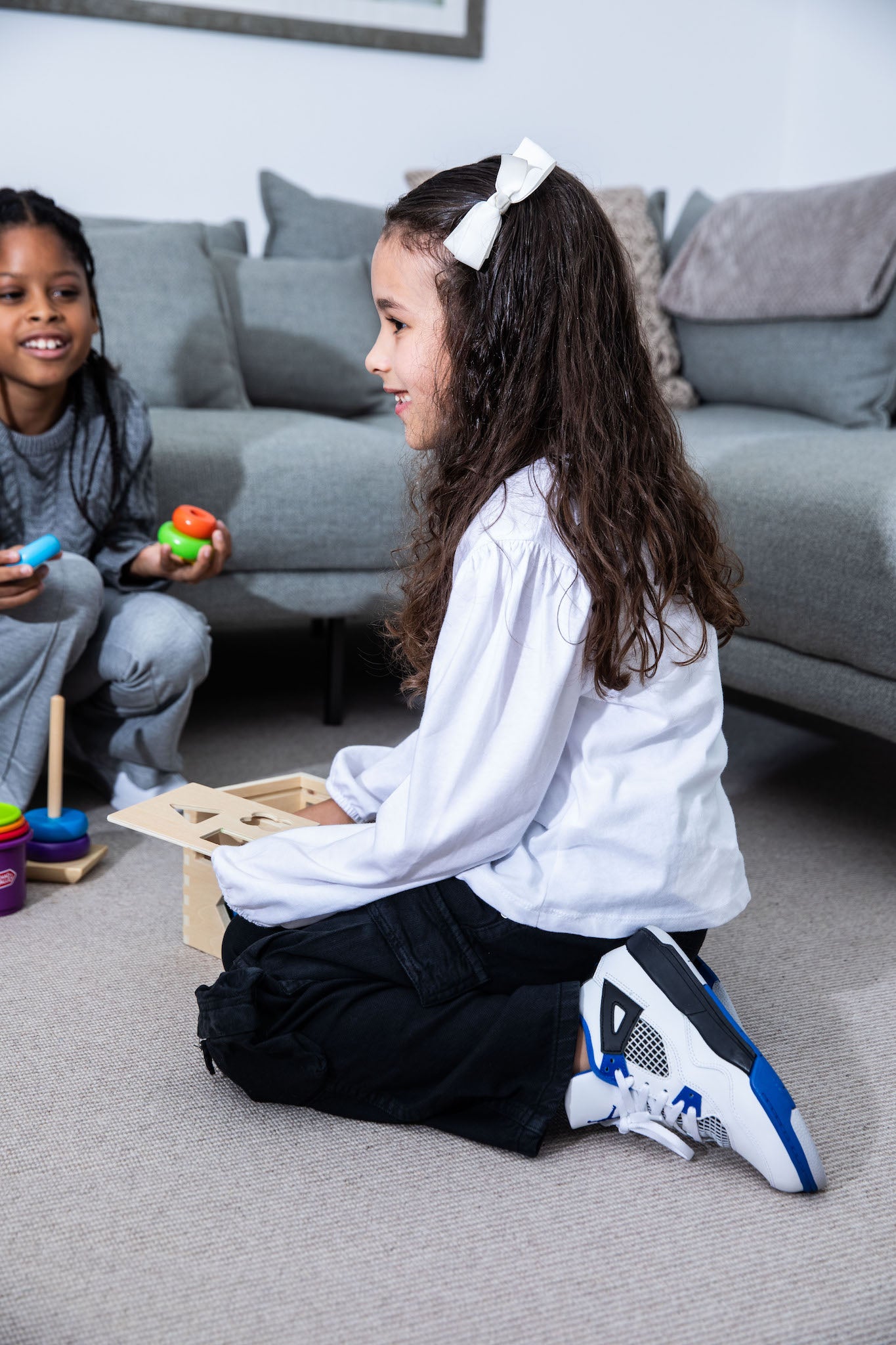 little girl wearing Air Jordan 4 Kids 'Motorsports' on foot