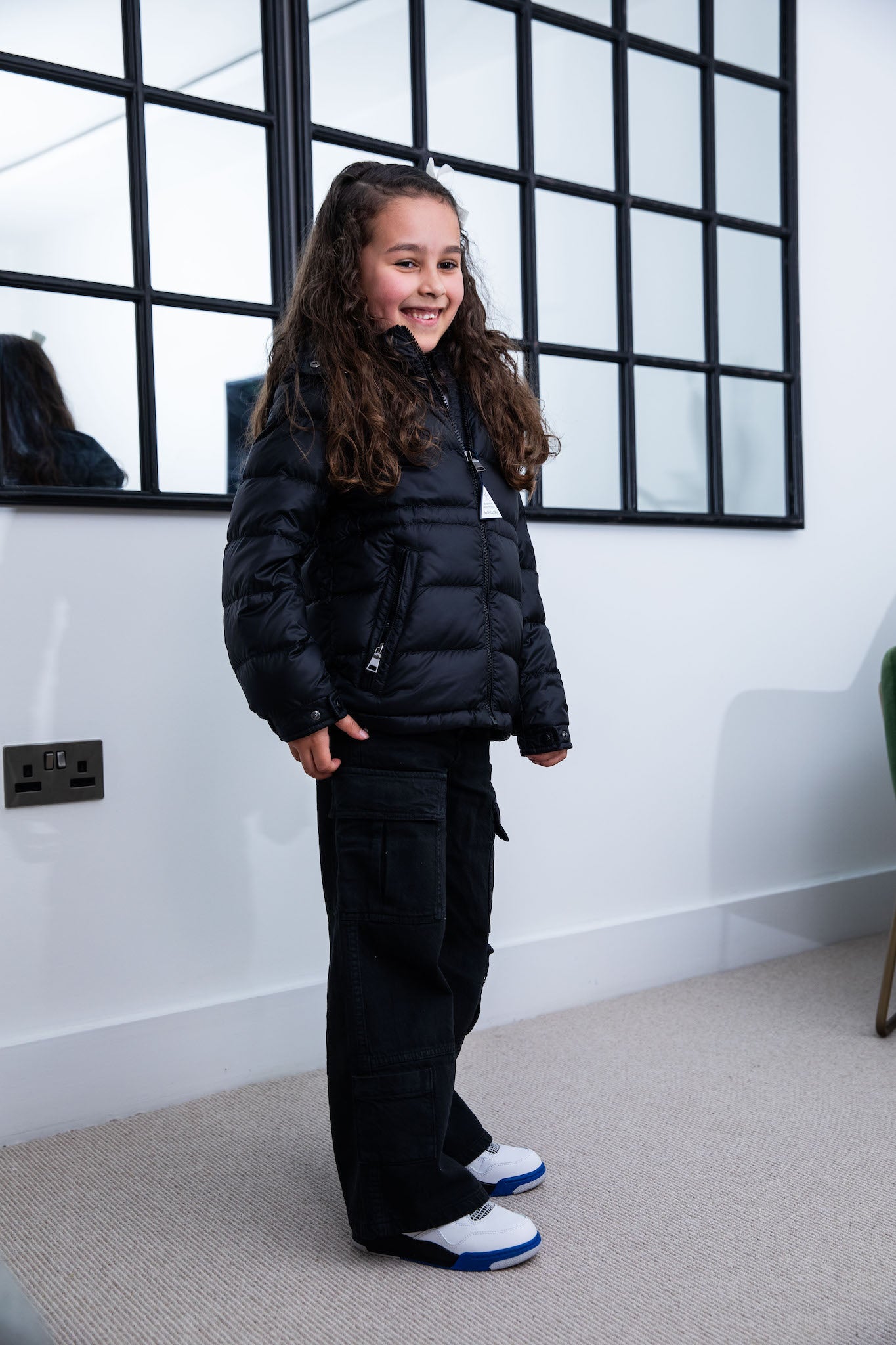 little girl wearing Air Jordan 4 Kids 'Motorsports' on foot