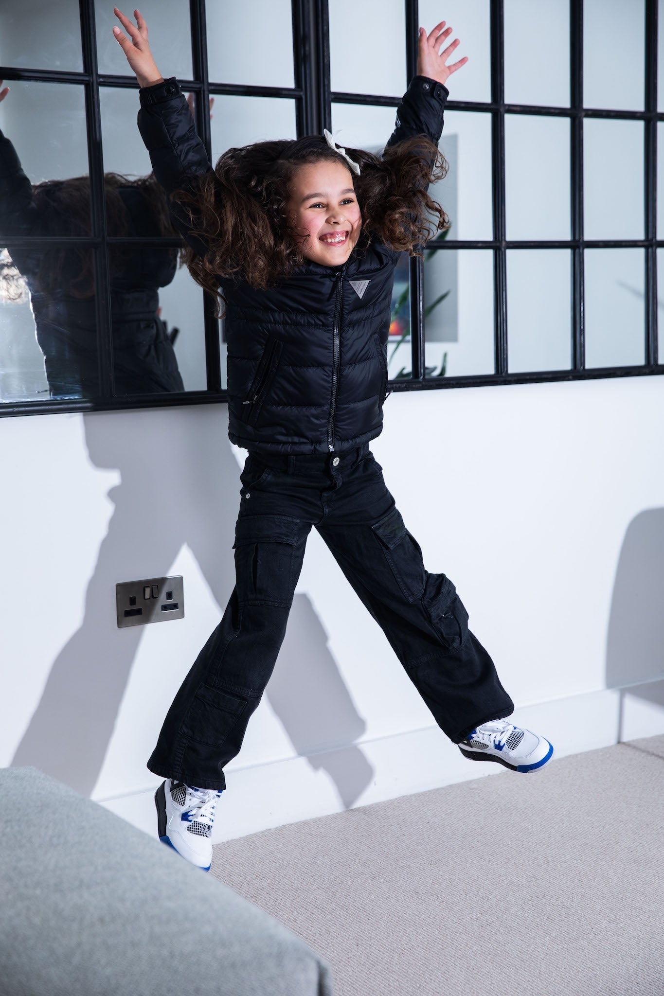 little girl wearing Air Jordan 4 Kids 'Motorsports' on foot