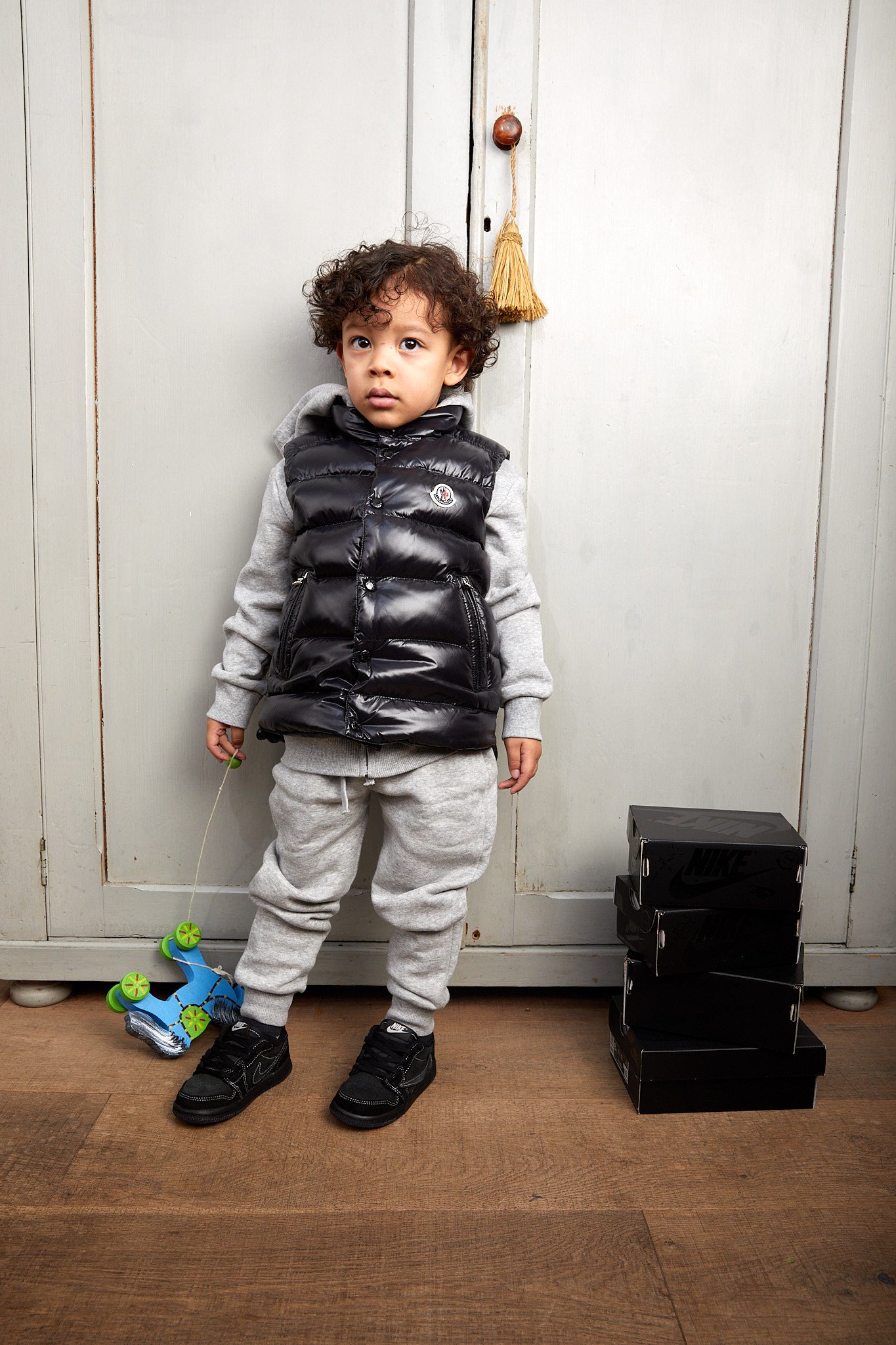 little boy wearing Air Jordan 1 Low x Travis Scott Kids 'Black Phantom'