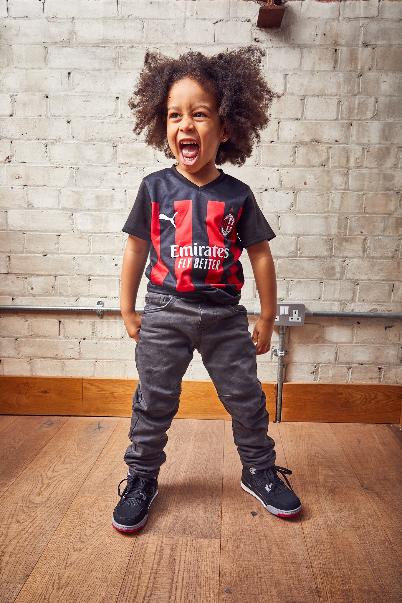 kid wearing Air Jordan 4 Kids 'Bred'