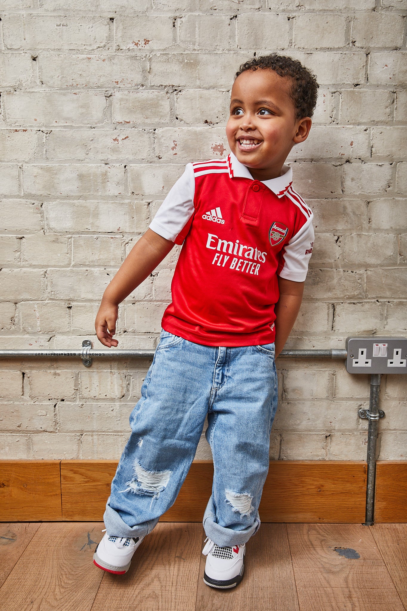 kid wearing Air Jordan 4 Kids 'What The'