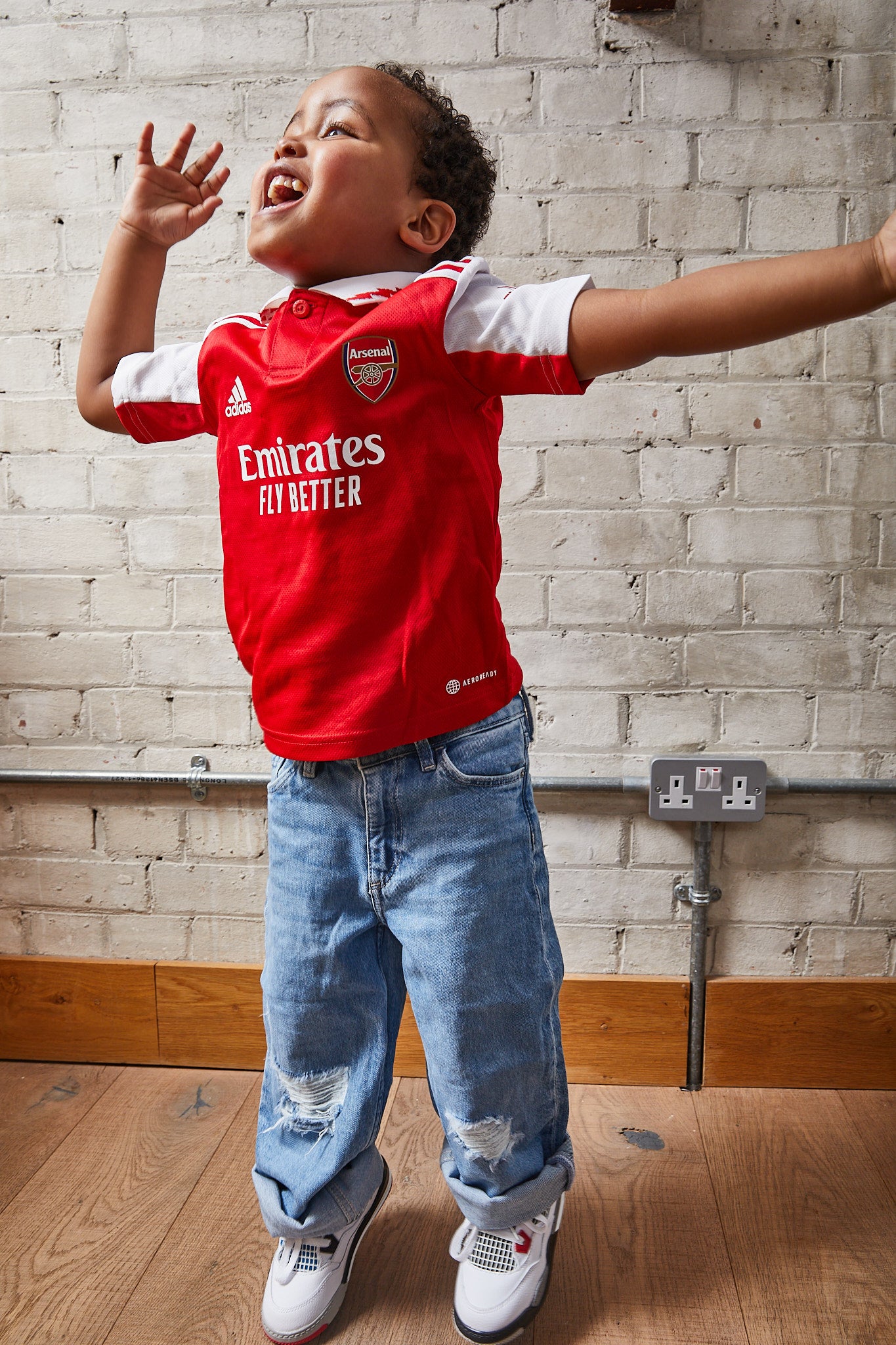 kid wearing Air Jordan 4 Kids 'What The'