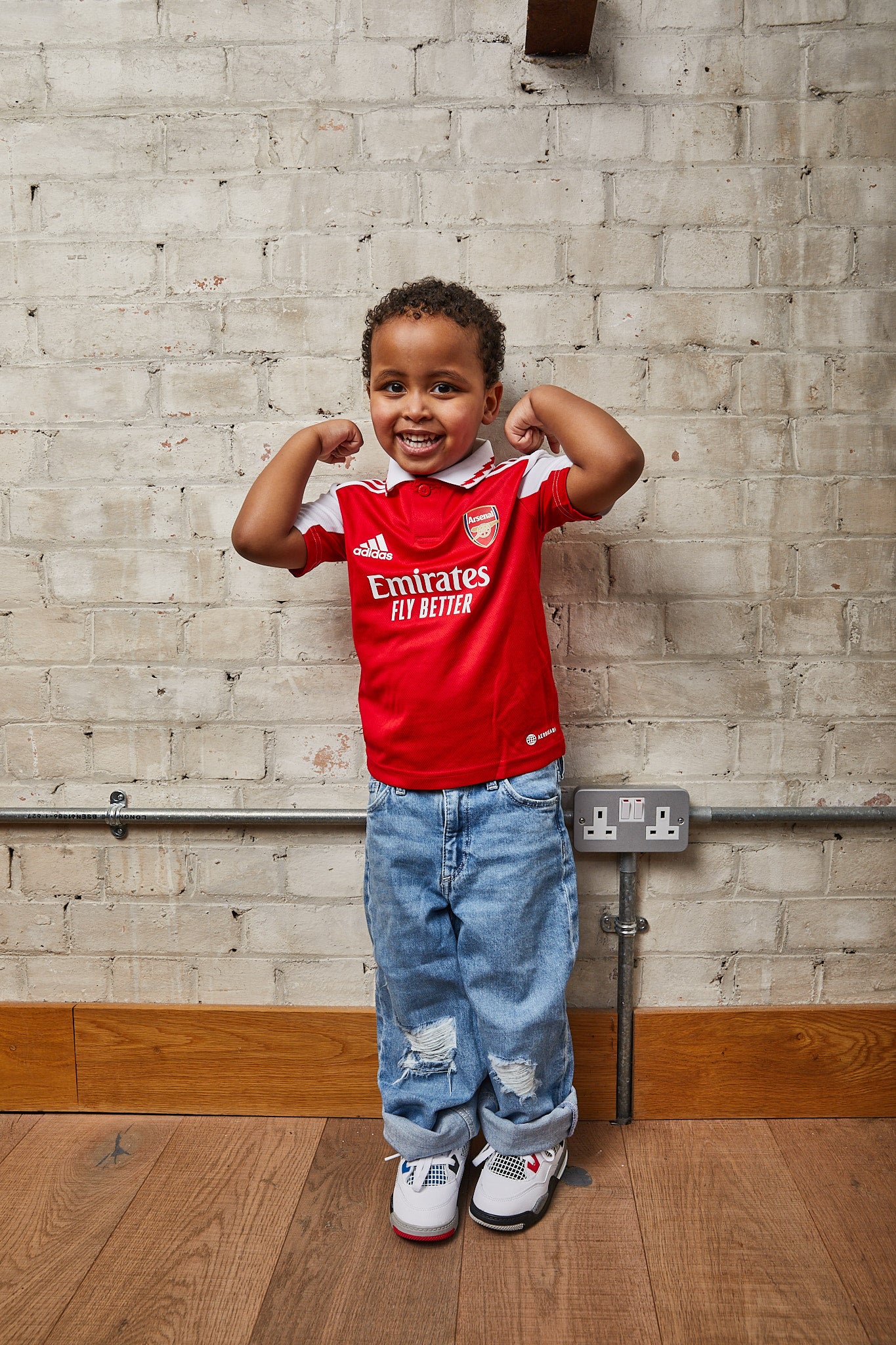 kid wearing Air Jordan 4 Kids 'What The'