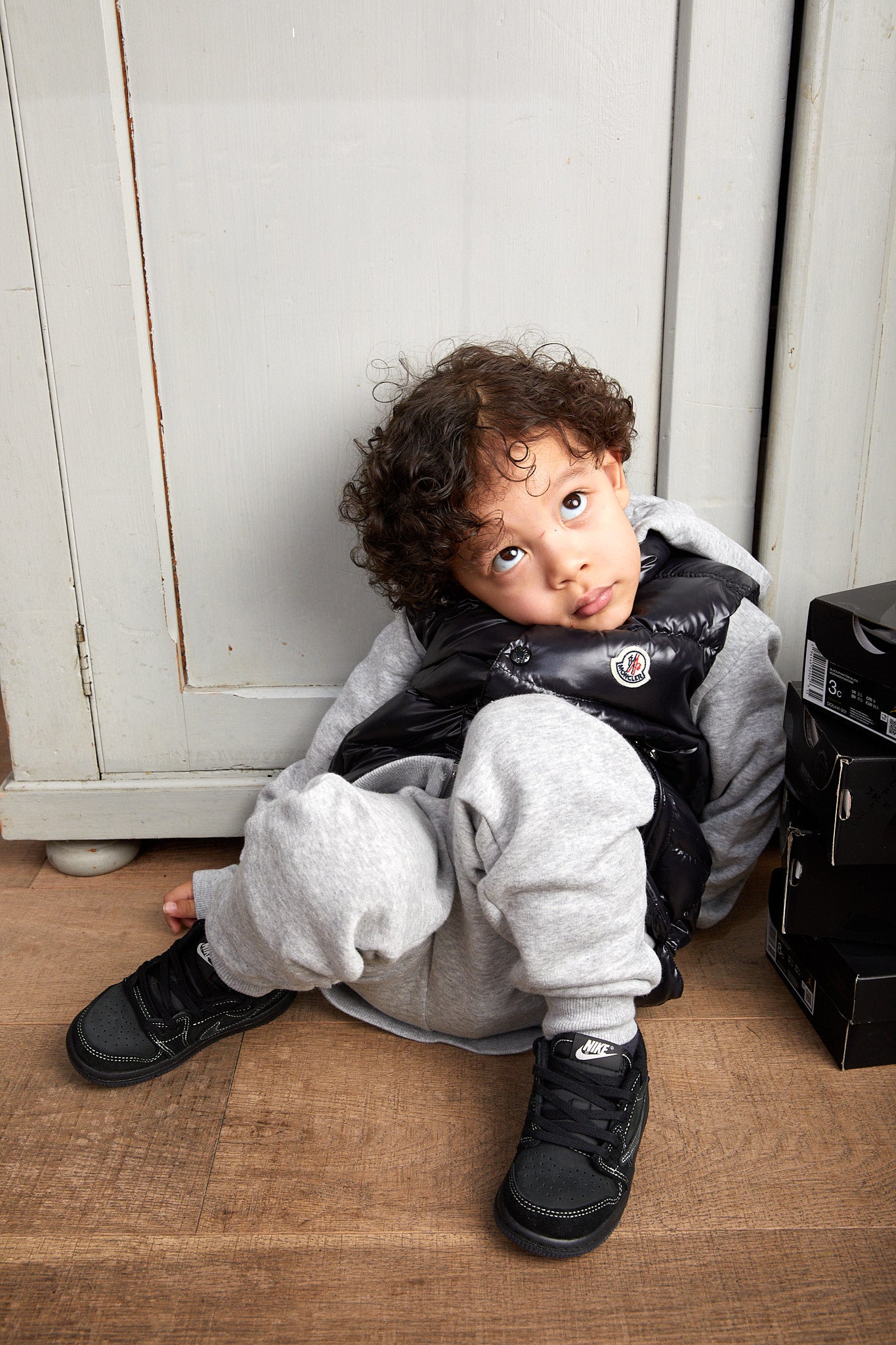 little boy wearing Air Jordan 1 Low x Travis Scott Kids 'Black Phantom'