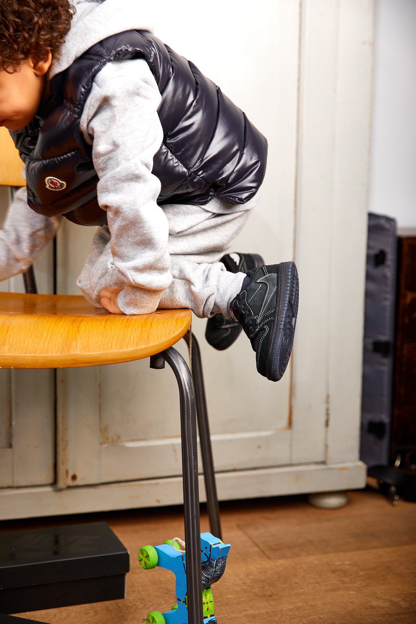 little boy wearing Air Jordan 1 Low x Travis Scott Kids 'Black Phantom'