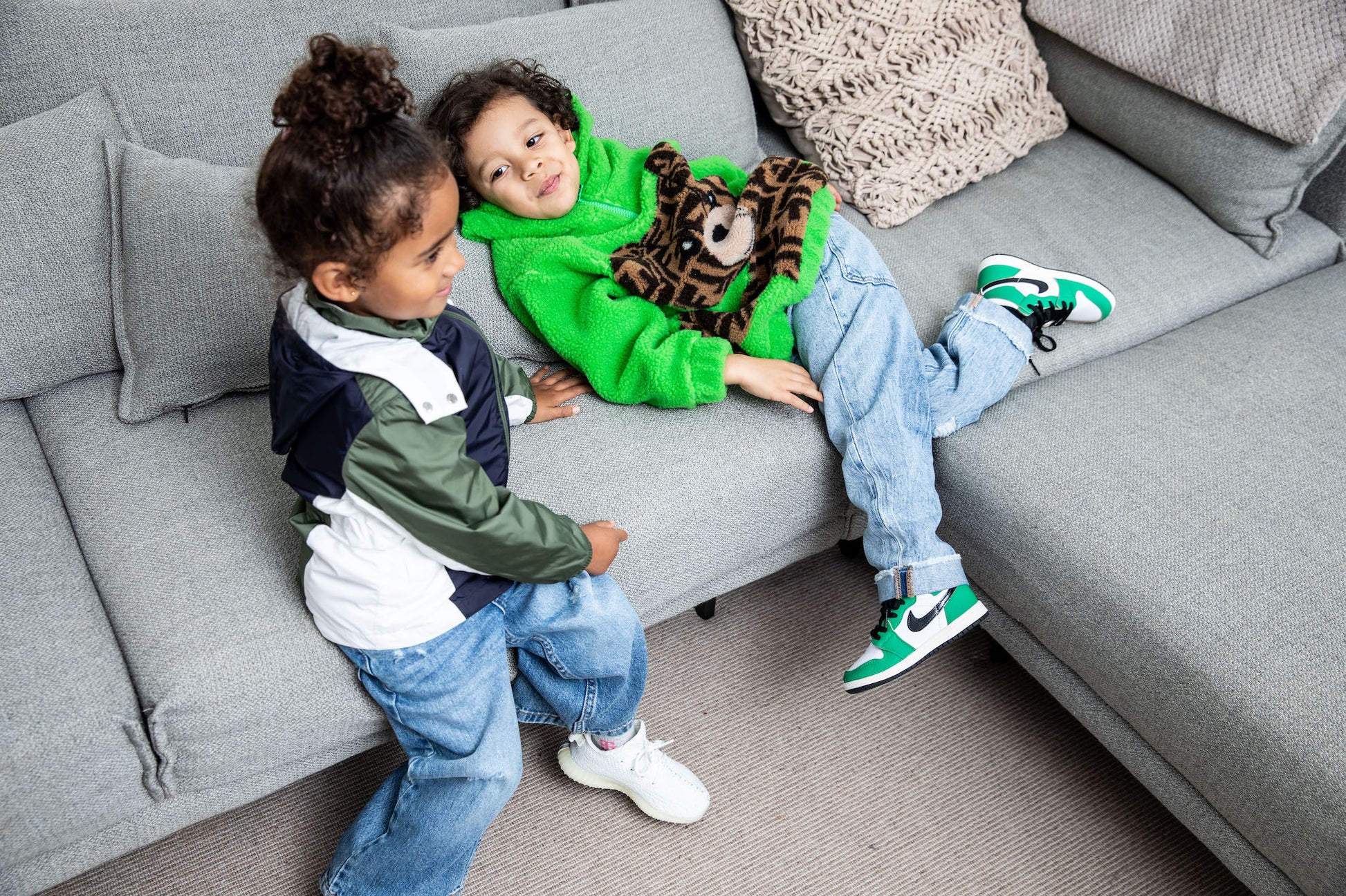little boy wearing Air Jordan 1 High Kids 'Lucky Green' on foot