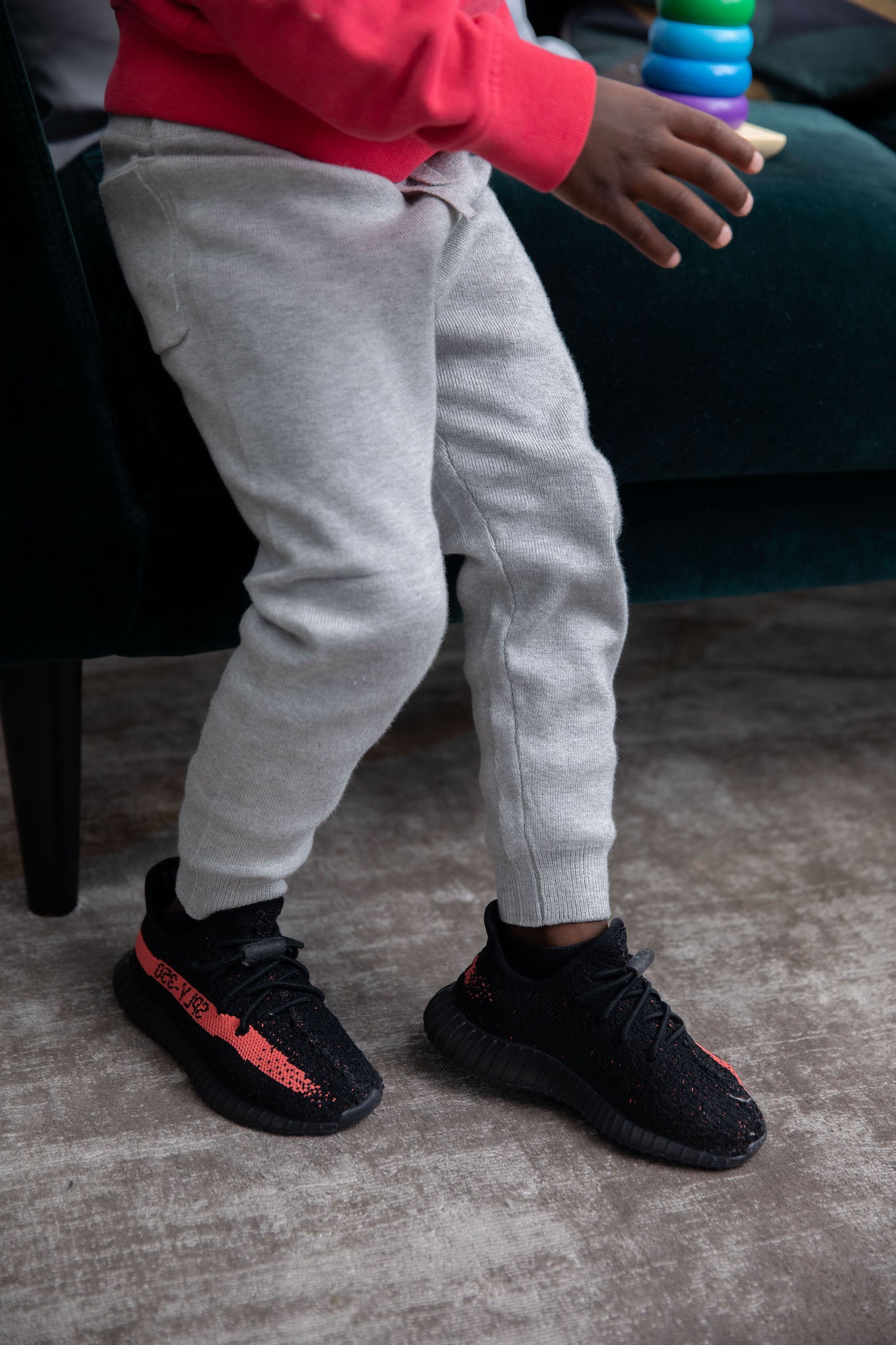 kid wearing Adidas Yeezy Boost 350 V2 Kids 'Core Black Red' on foot
