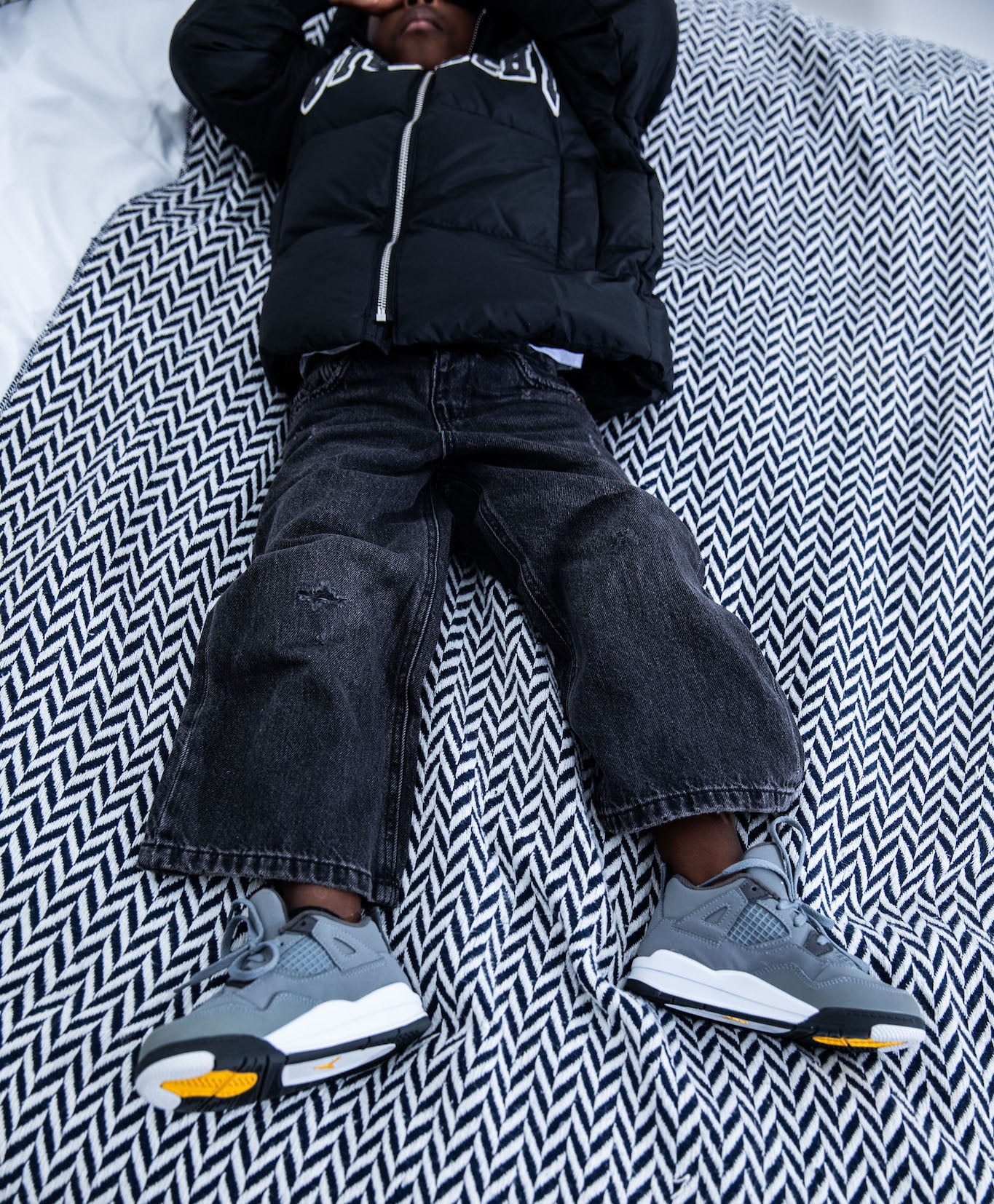kid wearing Air Jordan 4 Kids 'Cool Grey' on foot