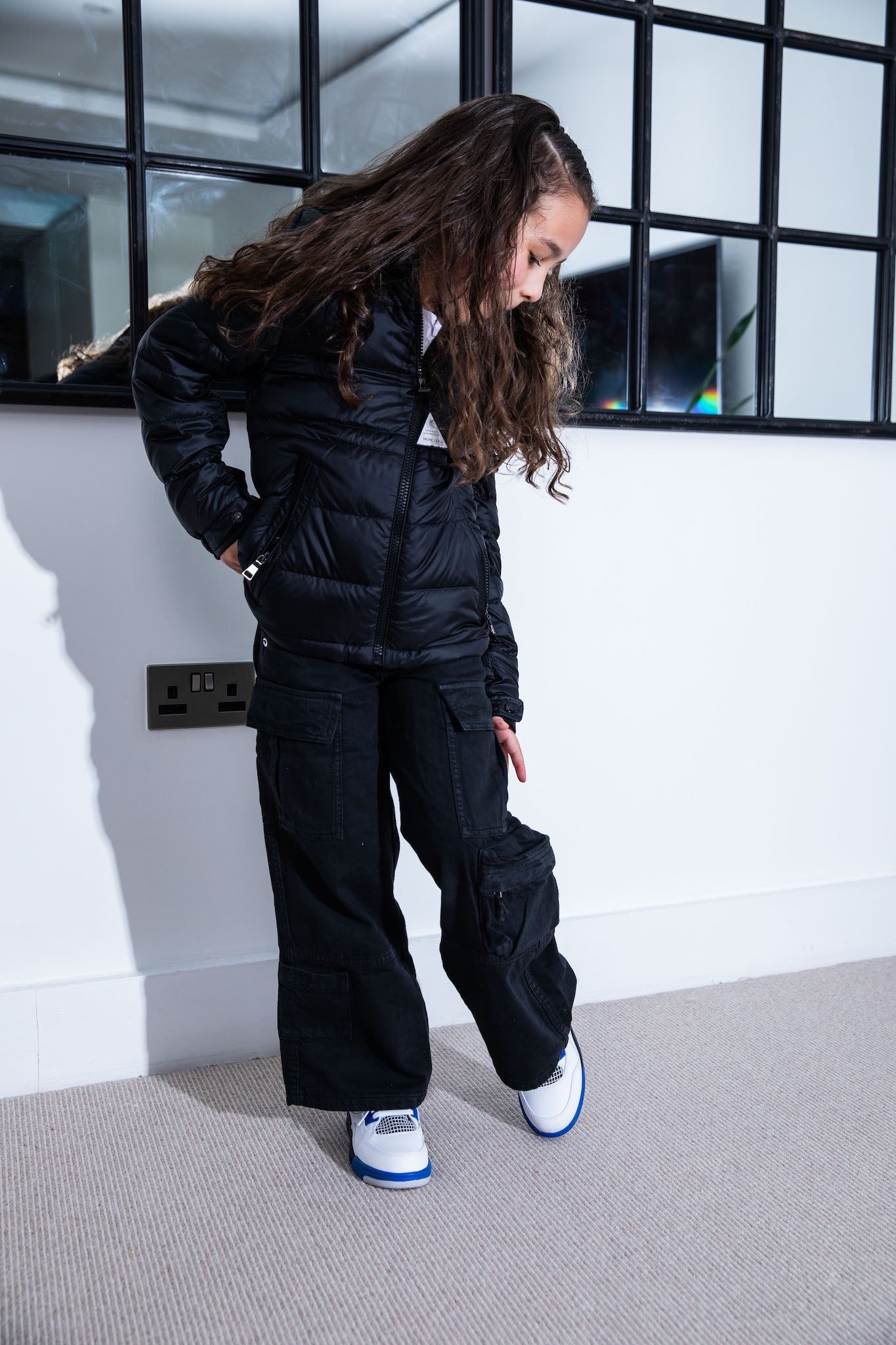 little girl wearing Air Jordan 4 Kids 'Motorsports' on foot
