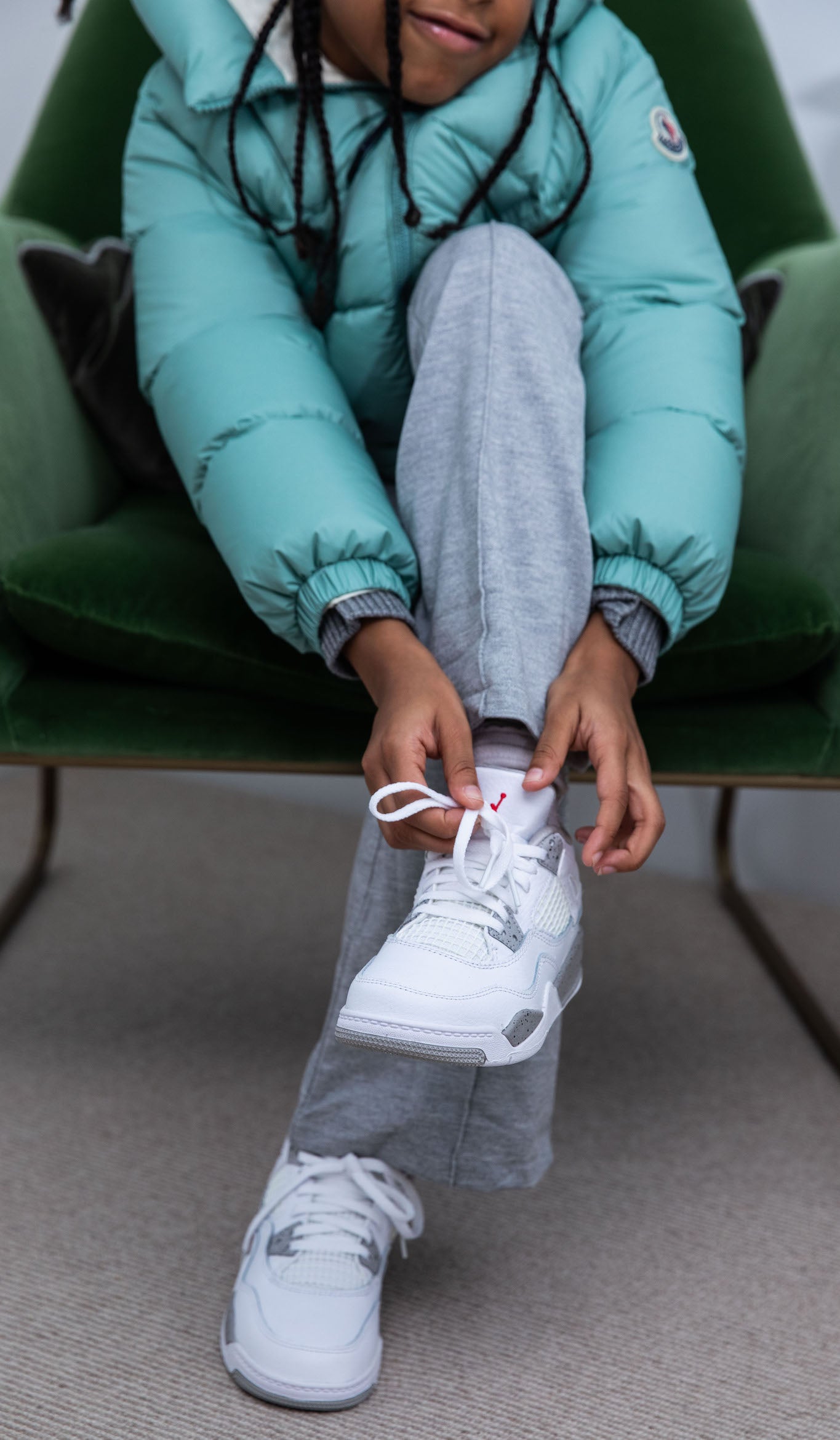 girl wearing Air Jordan 4 Kids 'White Oreo' on foot