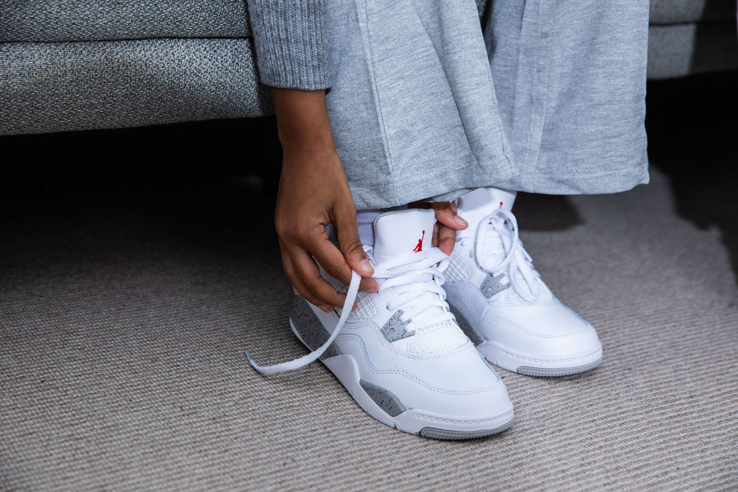 girl wearing Air Jordan 4 Kids 'White Oreo' on foot