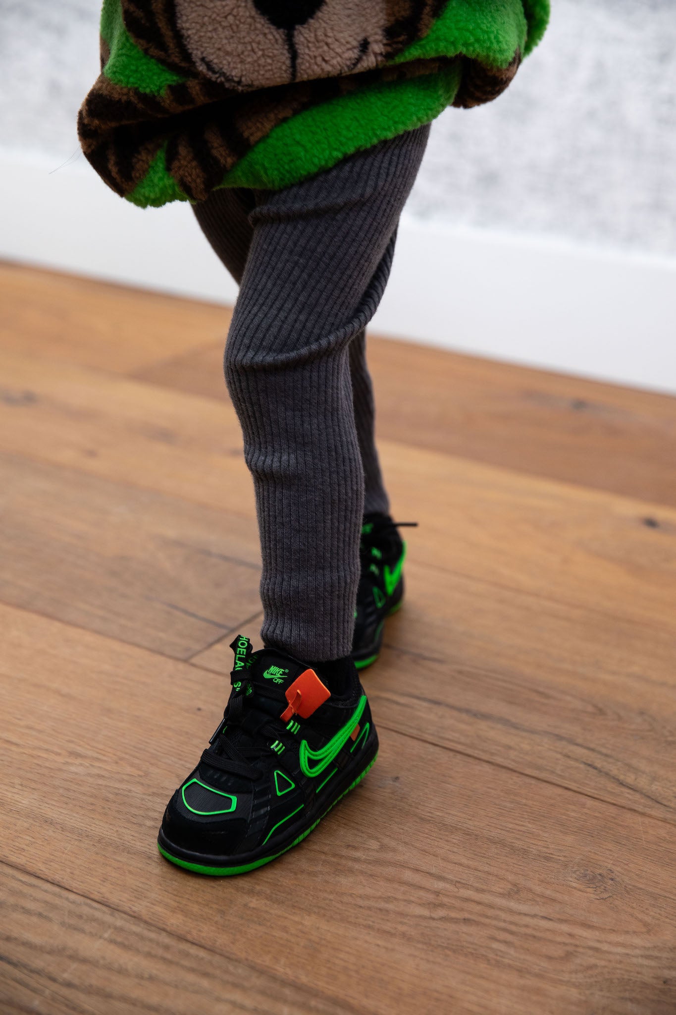 little girl wearing nike rubber dunk low off white green strike on foot